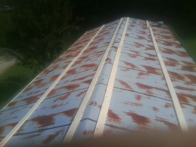 Rusted metal roof panels with new wood purlins before replacement — Storm Damage Roof Repair in Kendalia by Roofing Brothers